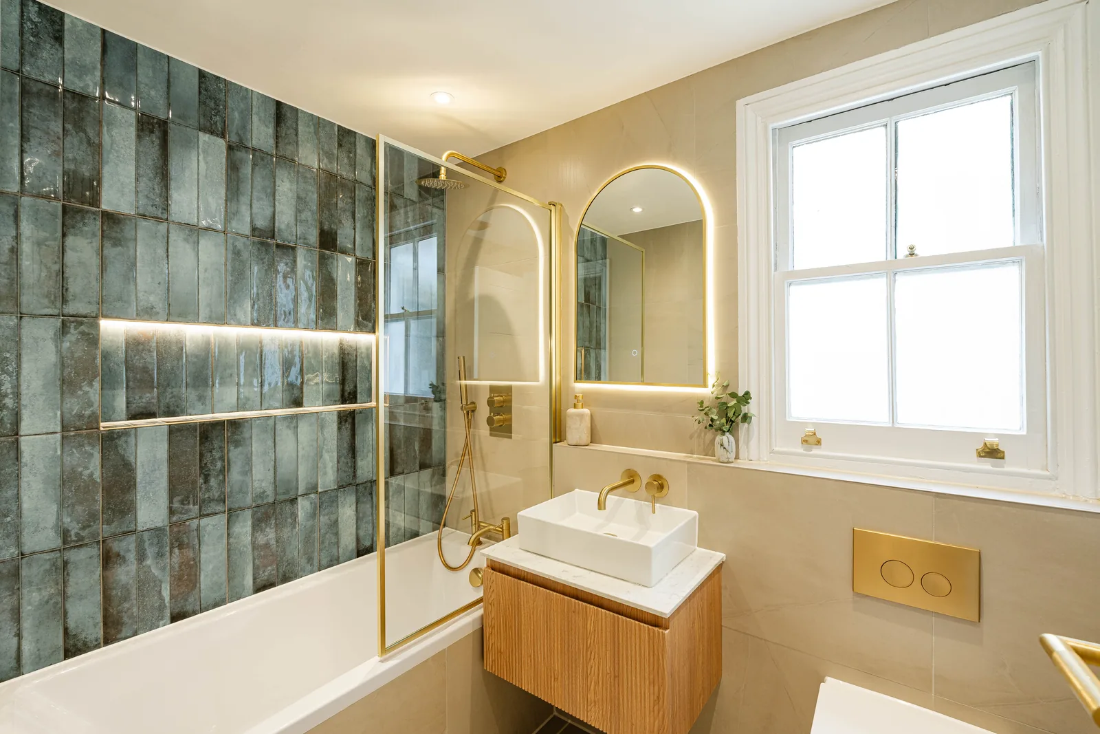 The bathroom, with the bath set under the window